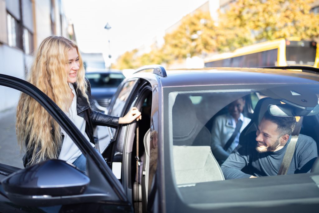 Woman Sitting In Car With Friends