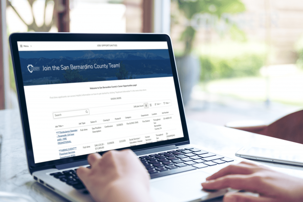 Person viewing San Bernardino County job listings on a laptop at a desk